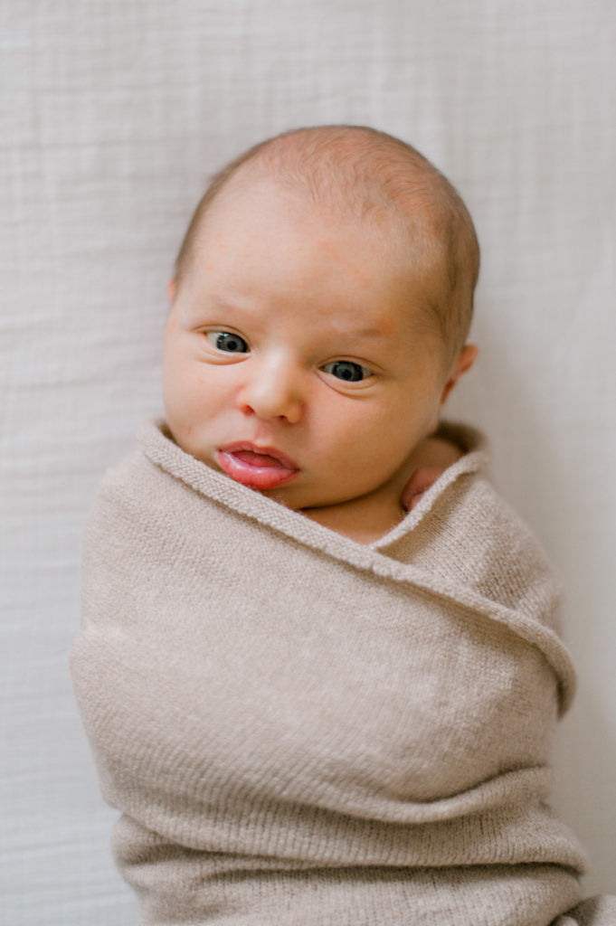 close up of newborn boy in a brown swaddle by cleveland newborn photographer, Brittany Serowski Photogaphy