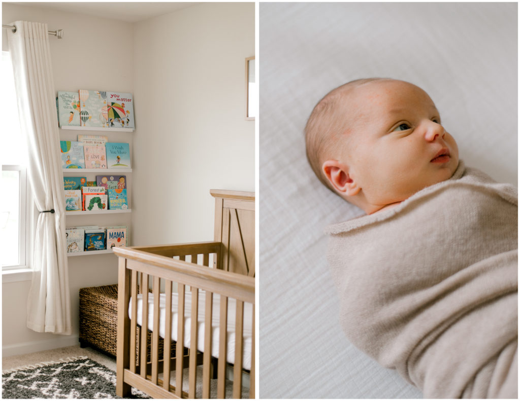 Newborn son wrapped in beige swaddle and a book wall in neutral nursery.