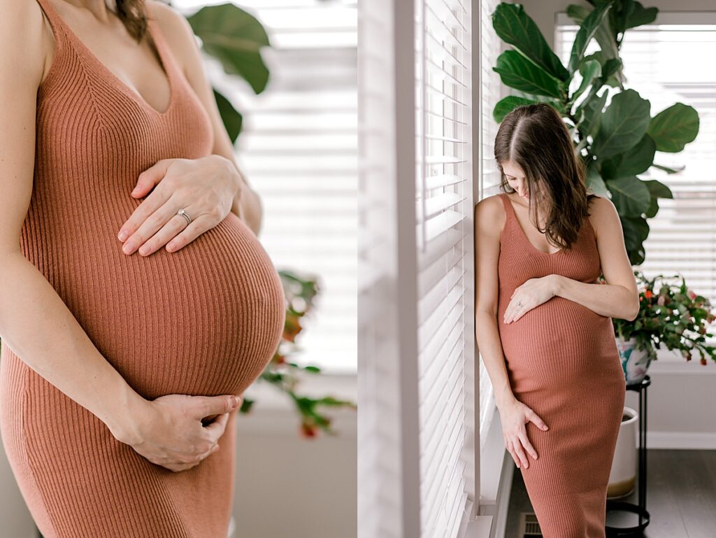 a pregnant mother holding her belly while standing in her kitchen for a north ridgeville maternity session by maternity photographer, Brittany Serowski Photography.