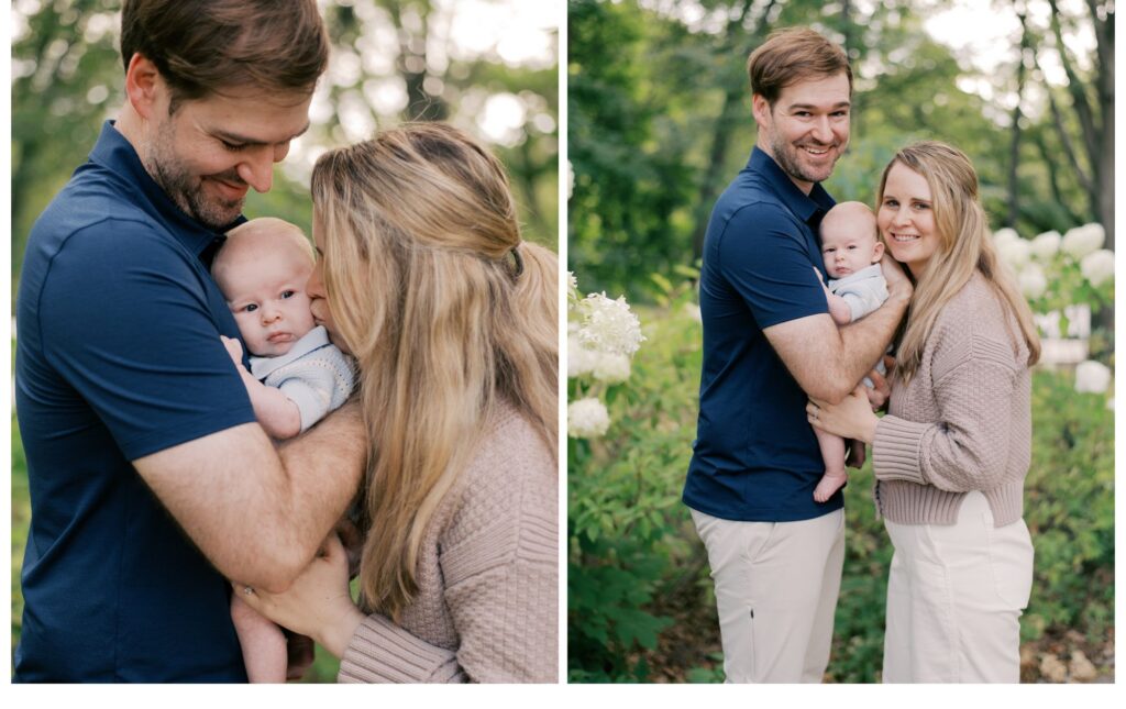 New parents, snuggling into their newborn son as they smile at the camera and kiss his cheeks. In front of the flowering hydrangea bushes at Cleveland Cultural Gardens for spring family photos in Cleveland. Captured by Cleveland Family Photographer, Brittany Serowski Photography.
