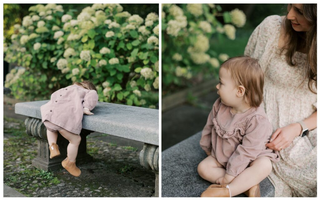 Spring Flowers in Cleveland. A toddler girl, in a pink dress, climbs onto a stone bench at the Cleveland Cultural Gardens. Captured by Cleveland Family Photographer, Brittany Serowski Photography.